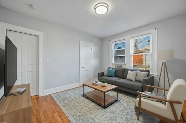 a living room with couch and a wooden floor