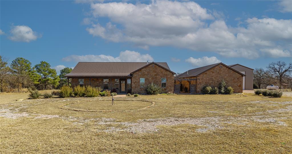 1433 County Road 1180 Decatur, TX 76234 - Photo 1 of 36 a front view of a house with a yard and garage