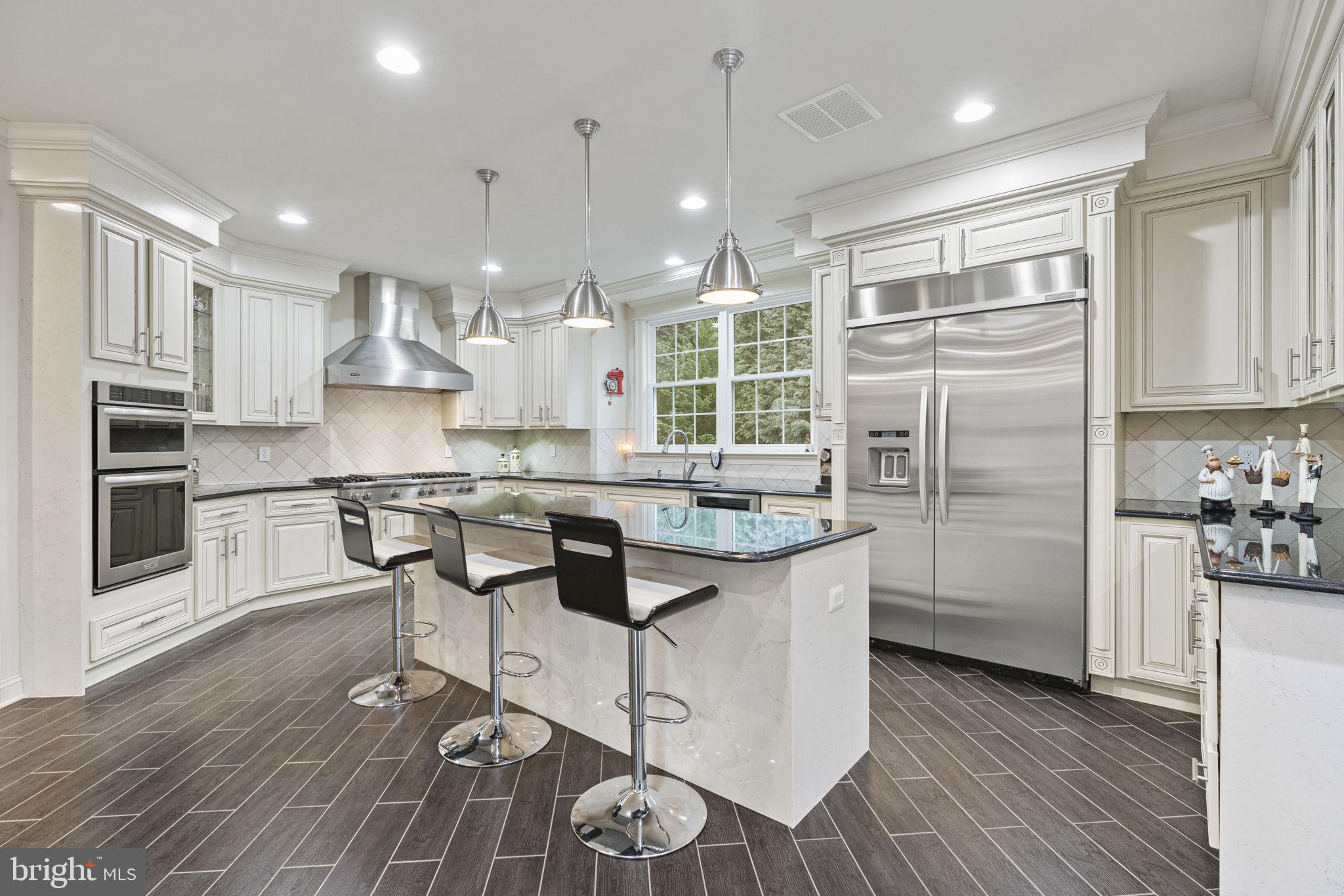 1204 Allendale Road McLean, VA 22101 - Photo 12 of 62 a kitchen with stainless steel appliances granite countertop a refrigerator a stove and a wooden floors