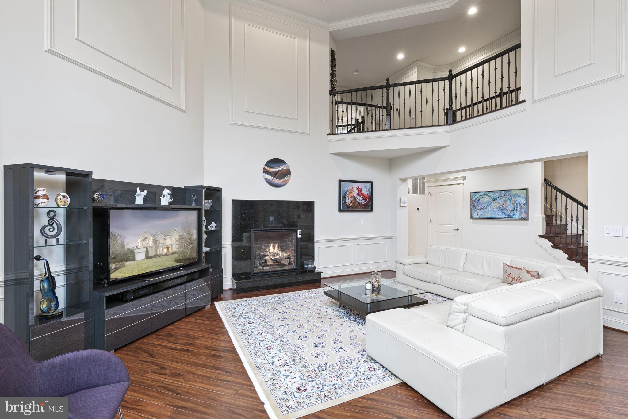 1204 Allendale Road McLean, VA 22101 - Photo 19 of 62 a living room with furniture a flat screen tv and a fireplace