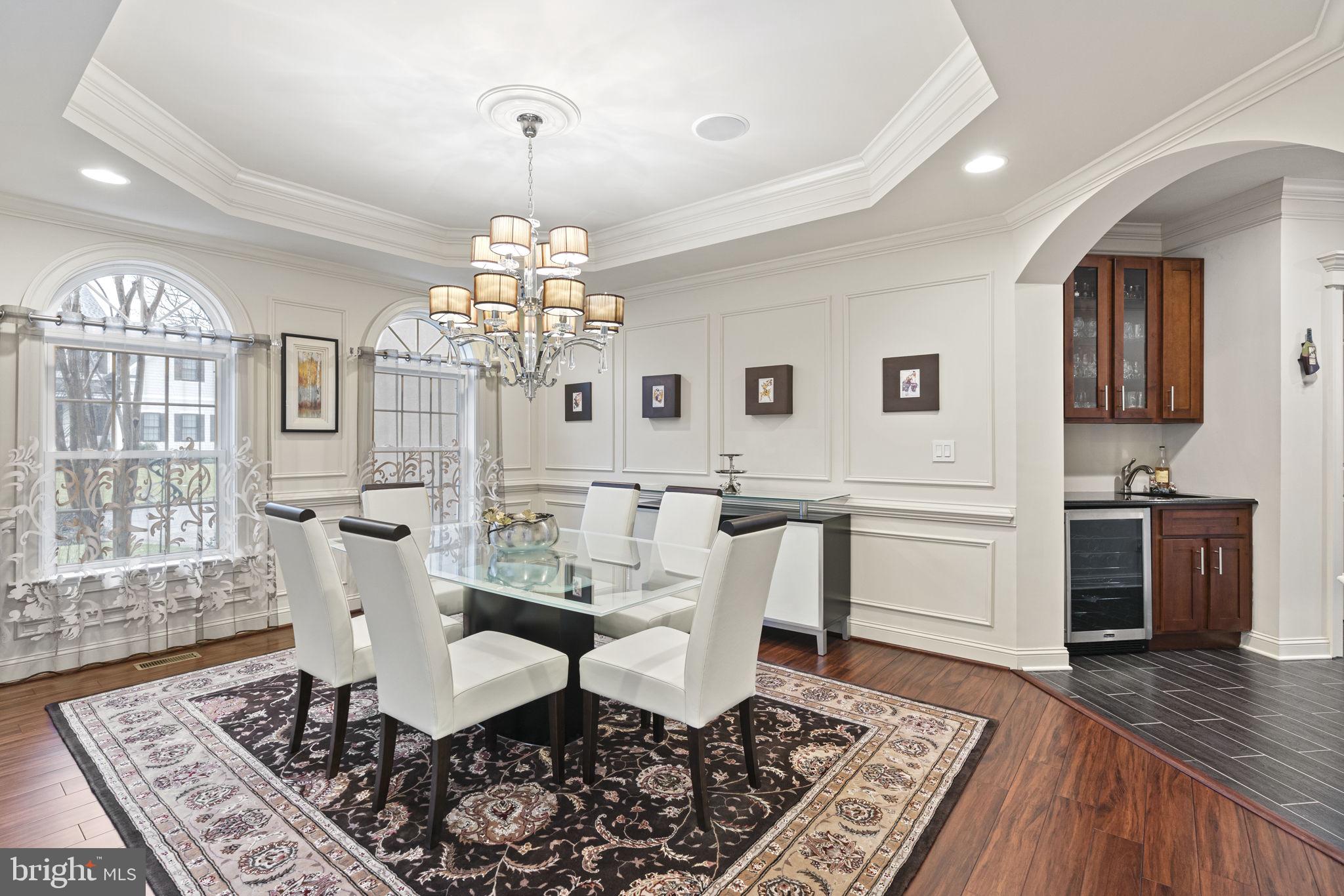 1204 Allendale Road McLean, VA 22101 - Photo 20 of 62 a dining room with wooden floor a chandelier a wooden table and chairs