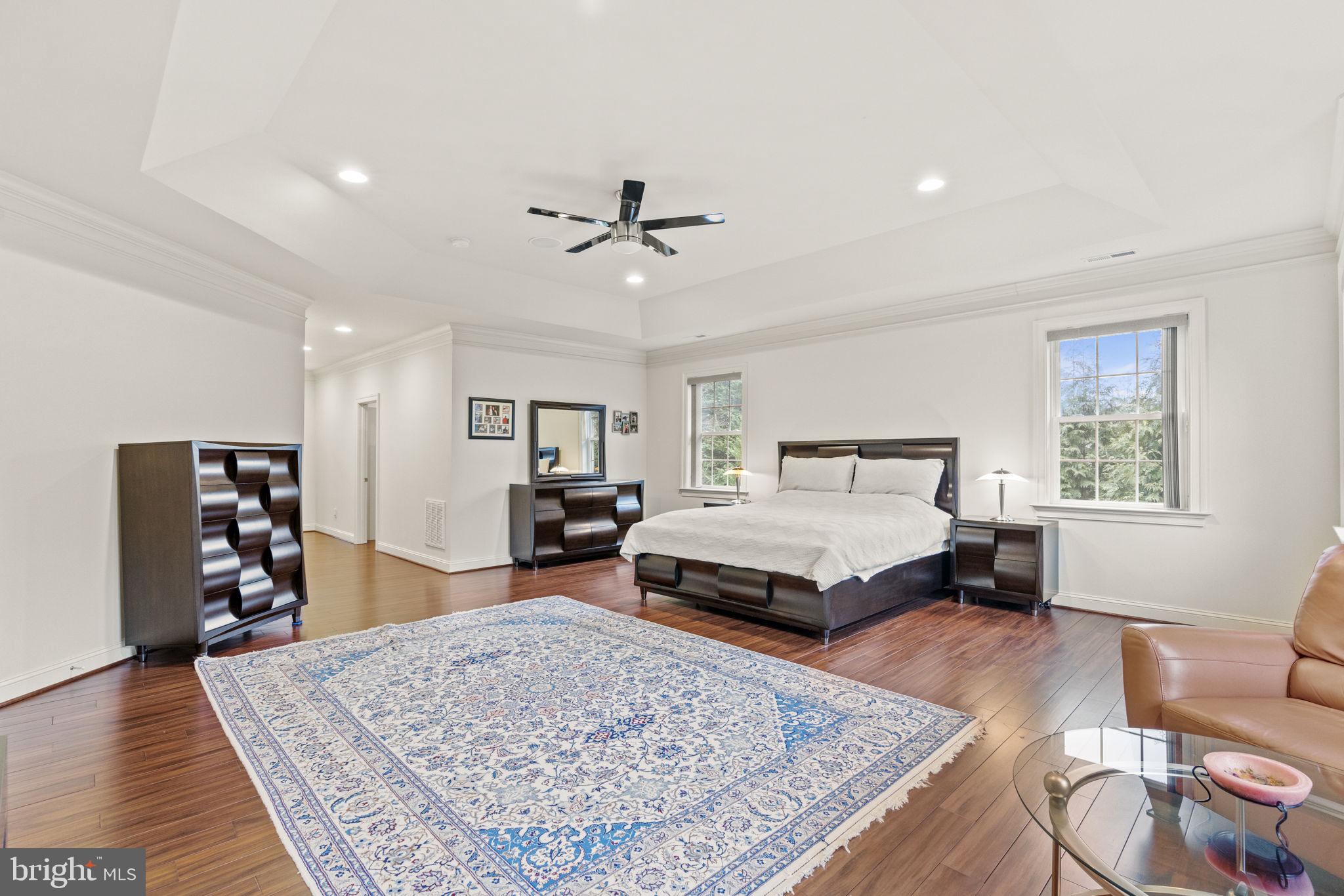 1204 Allendale Road McLean, VA 22101 - Photo 29 of 62 a spacious bedroom with a bed a couch and bookshelf