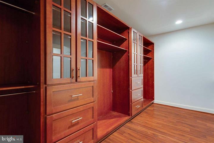 1204 Allendale Road McLean, VA 22101 - Photo 33 of 62 an empty room with wooden floor and cabinet