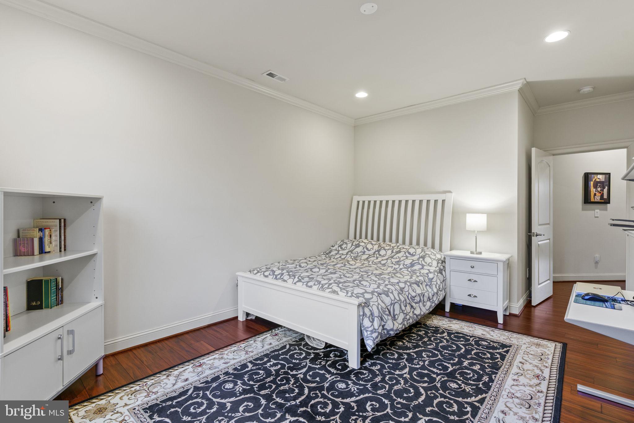 1204 Allendale Road McLean, VA 22101 - Photo 37 of 62 a room with a baby crib and a couch