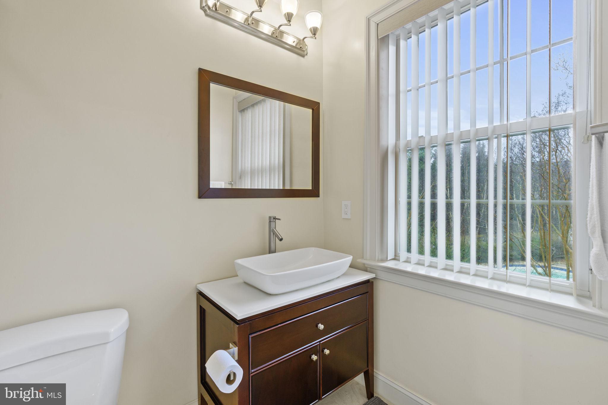 1204 Allendale Road McLean, VA 22101 - Photo 39 of 62 a bathroom with a sink a vanity and a toilet
