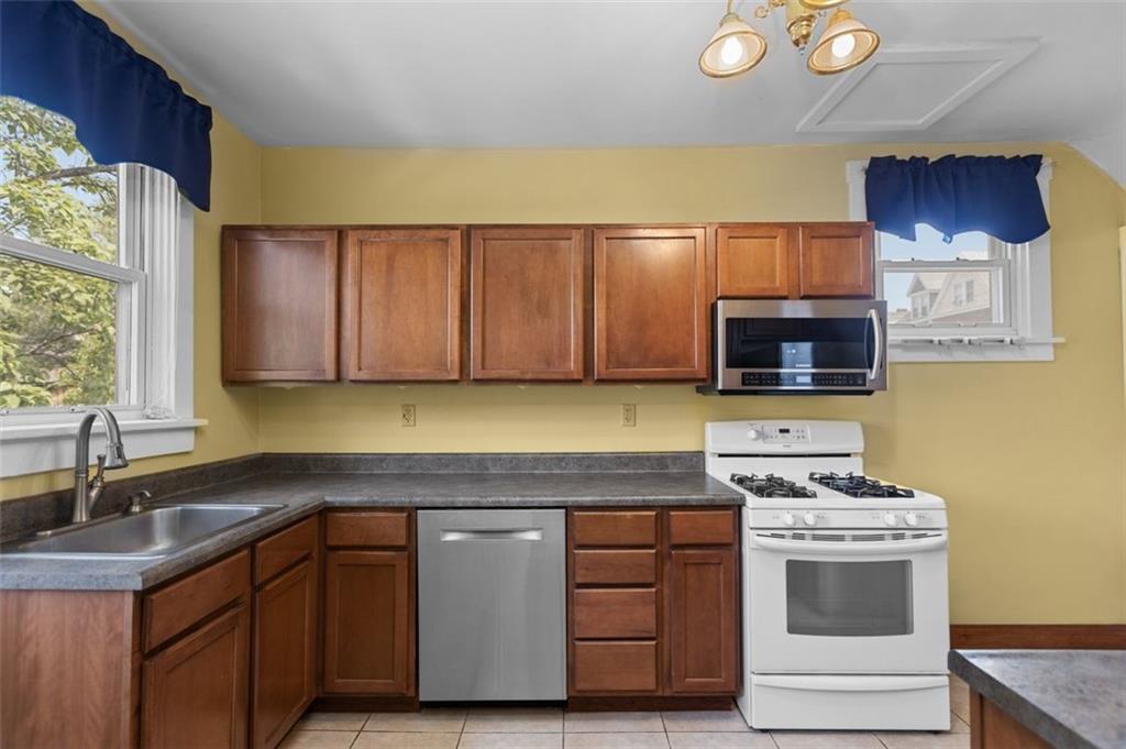 11 Butler Street Pittsburgh, PA 15209 - Photo 13 of 29 a kitchen with stainless steel appliances a stove a sink and a microwave