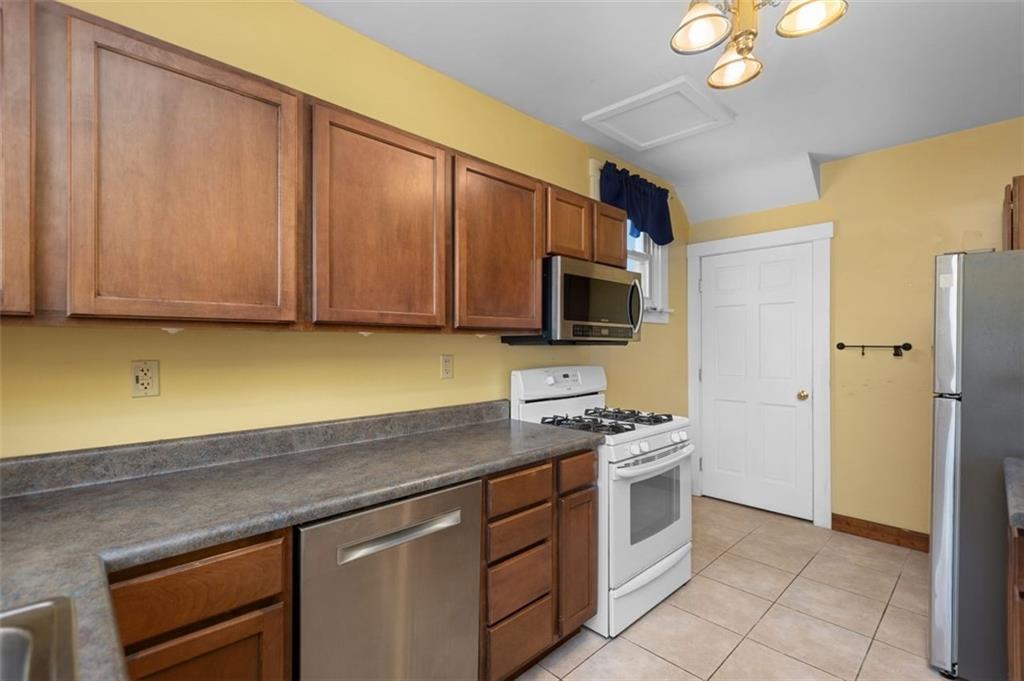 11 Butler Street Pittsburgh, PA 15209 - Photo 14 of 29 a kitchen with stainless steel appliances a stove microwave and refrigerator