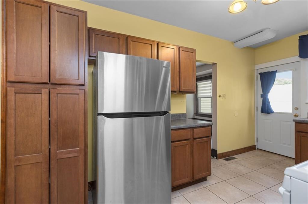 11 Butler Street Pittsburgh, PA 15209 - Photo 15 of 29 a white refrigerator freezer and a stove sitting inside of a kitchen