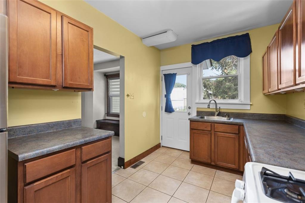 11 Butler Street Pittsburgh, PA 15209 - Photo 16 of 29 a kitchen with stainless steel appliances granite countertop a sink and a refrigerator