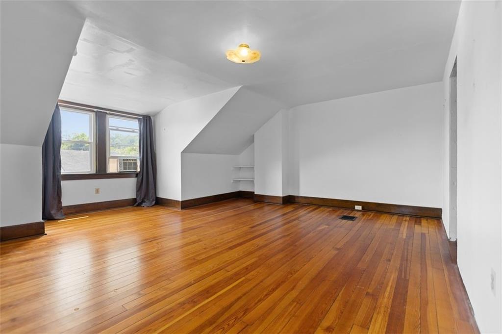 11 Butler Street Pittsburgh, PA 15209 - Photo 25 of 29 a view of an empty room with wooden floor and a window