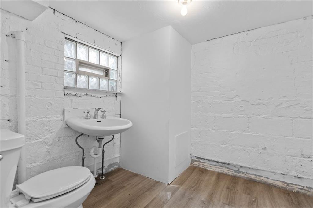11 Butler Street Pittsburgh, PA 15209 - Photo 27 of 29 a bathroom with a sink toilet and a mirror