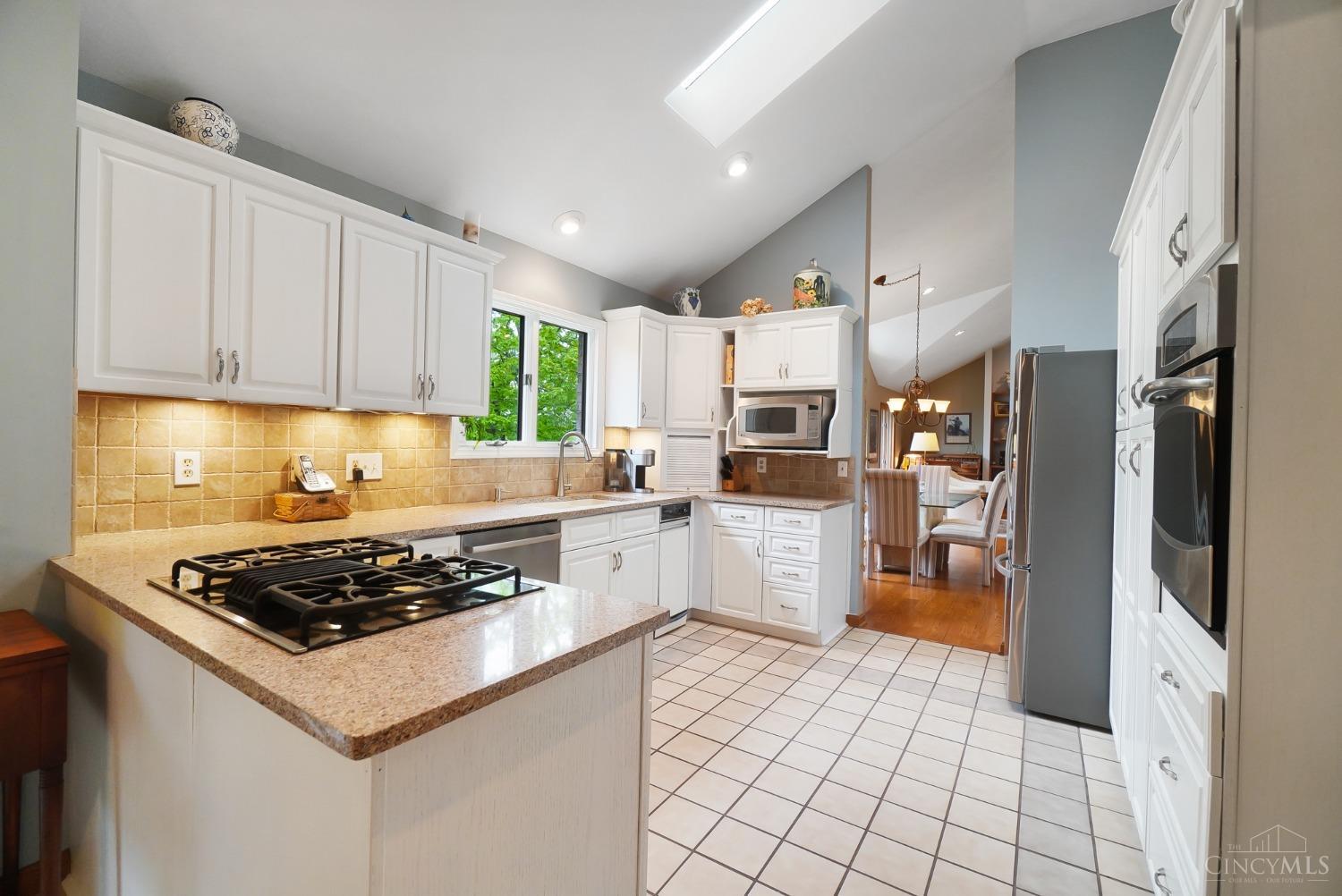 10907 Sand Run Road Harrison, OH 45030 - Photo 22 of 88 Soft-close cabinetry, quartz counters, stainless appliances, tile backsplash and cathedral ceilings with skylight!