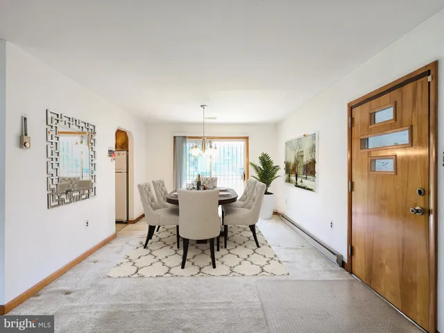 a living room with furniture a large window and wood floor