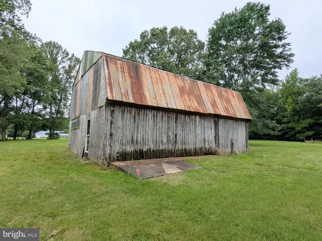 a view of a backyard with a cabin and wooden fence