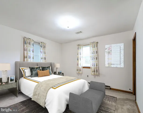 a bedroom with bed and window