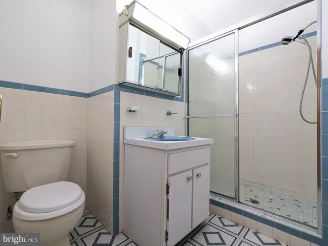 a bathroom with a sink mirror vanity and toilet