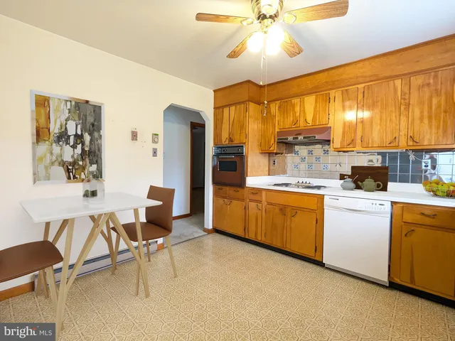 a kitchen with a table chairs refrigerator and cabinets