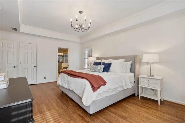 a spacious bedroom with a bed and a chair