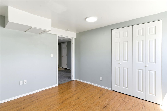 1613 Sunset Road Lake Point, UT 84074 - Photo 21 of 33 Light-toned wood-finish flooring complements the neutral wall color