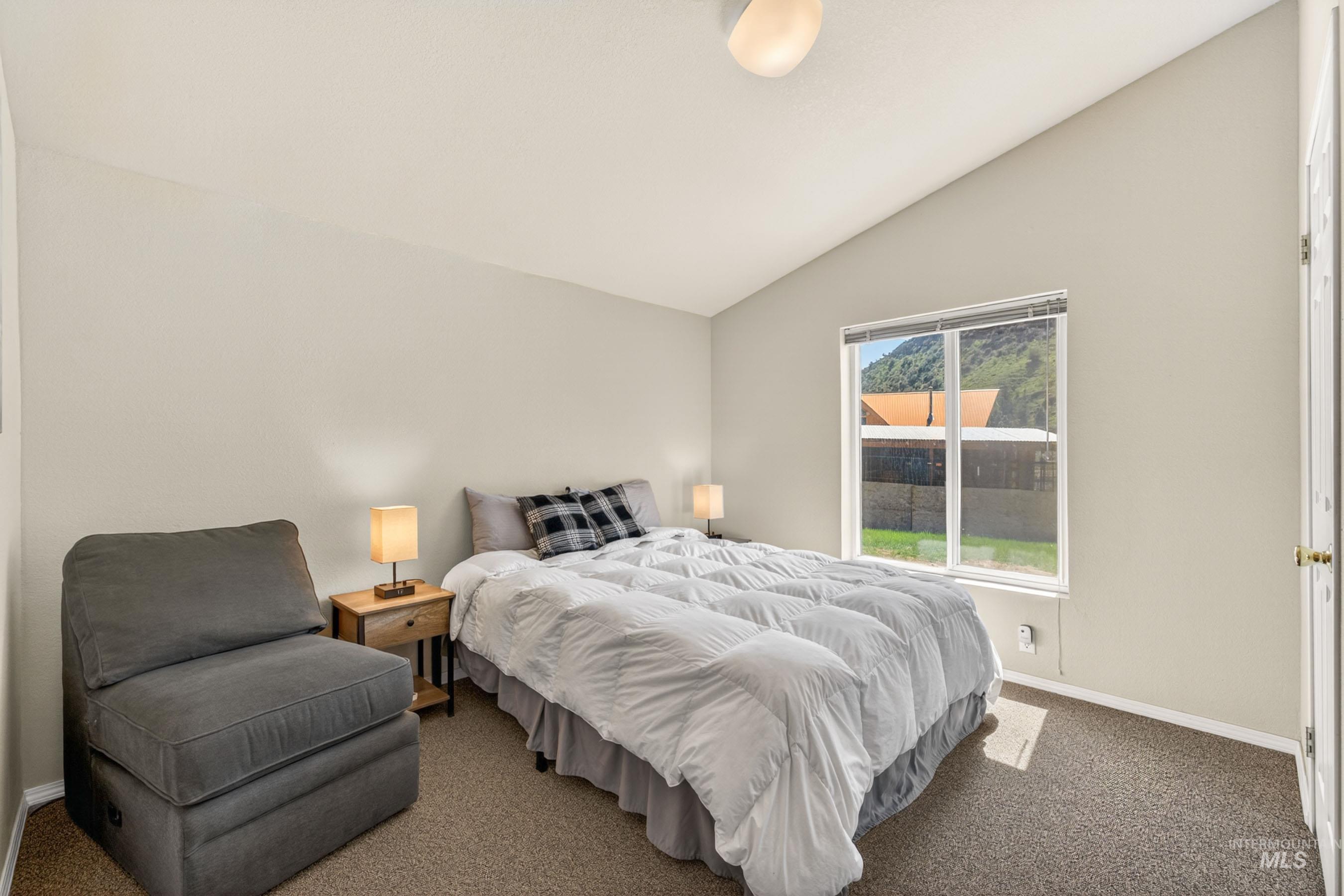 151 Cow Creek Road Lucile, ID 83542 - Photo 30 of 50 Vaulted ceiling bedroom with a large window