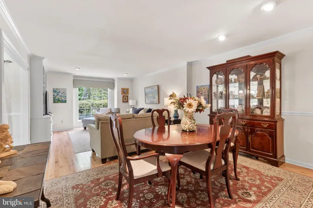 a dining room with furniture and wooden floor