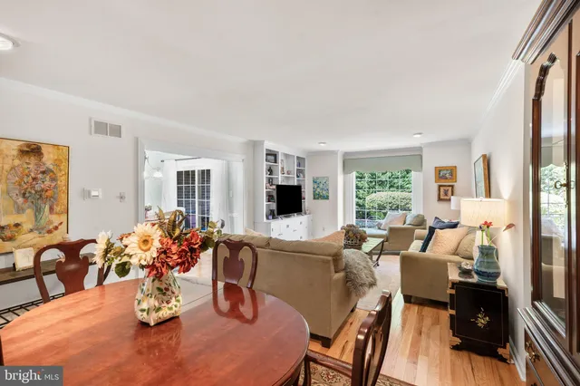 a dining room with furniture window and wooden floor