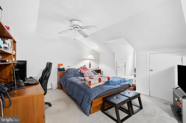 a living room with furniture a flat screen tv and a dresser