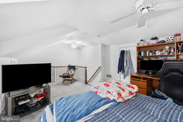 a bedroom with furniture and a flat screen tv