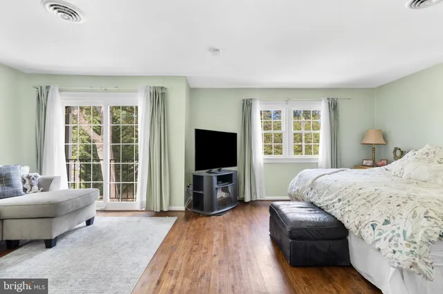a bedroom with furniture and a flat screen tv