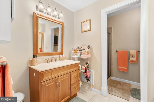a bathroom with a sink vanity and a mirror