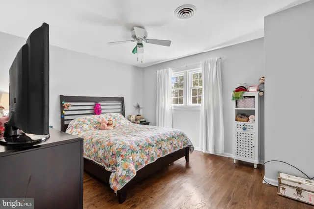 a bedroom with a bed and a desk