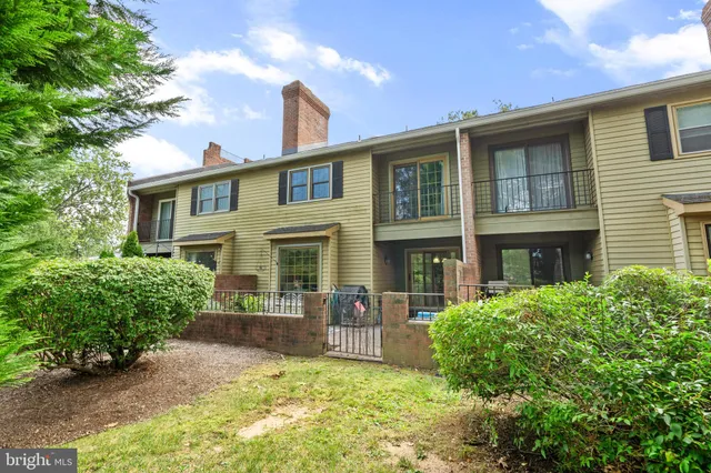a front view of house with yard and trees around