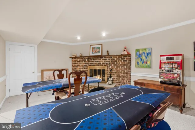 a living room with furniture pool table and window
