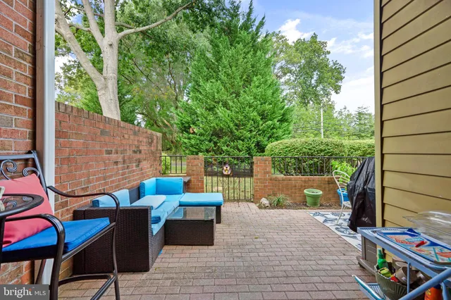 an outdoor sitting area with couch and chairs