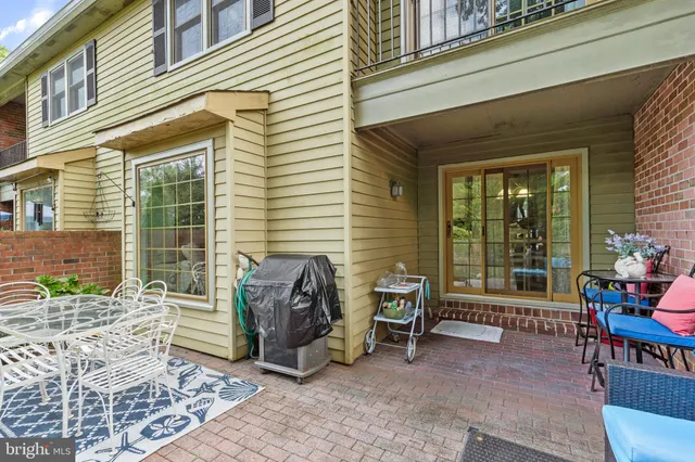 a view of a patio with table and chairs and potted plants
