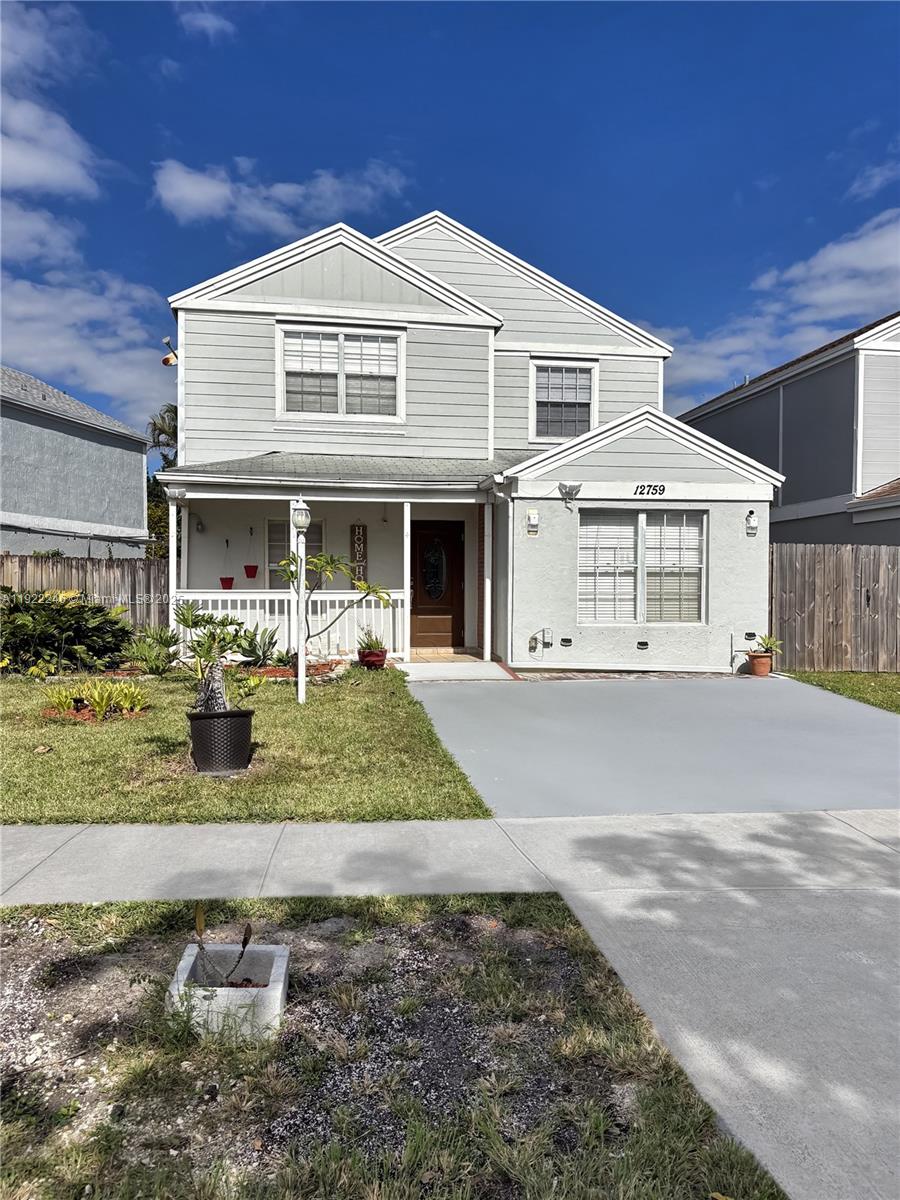 12759 Southwest 146th Terrace Miami, FL 33186 - Photo 1 of 10 a front view of a house with a yard