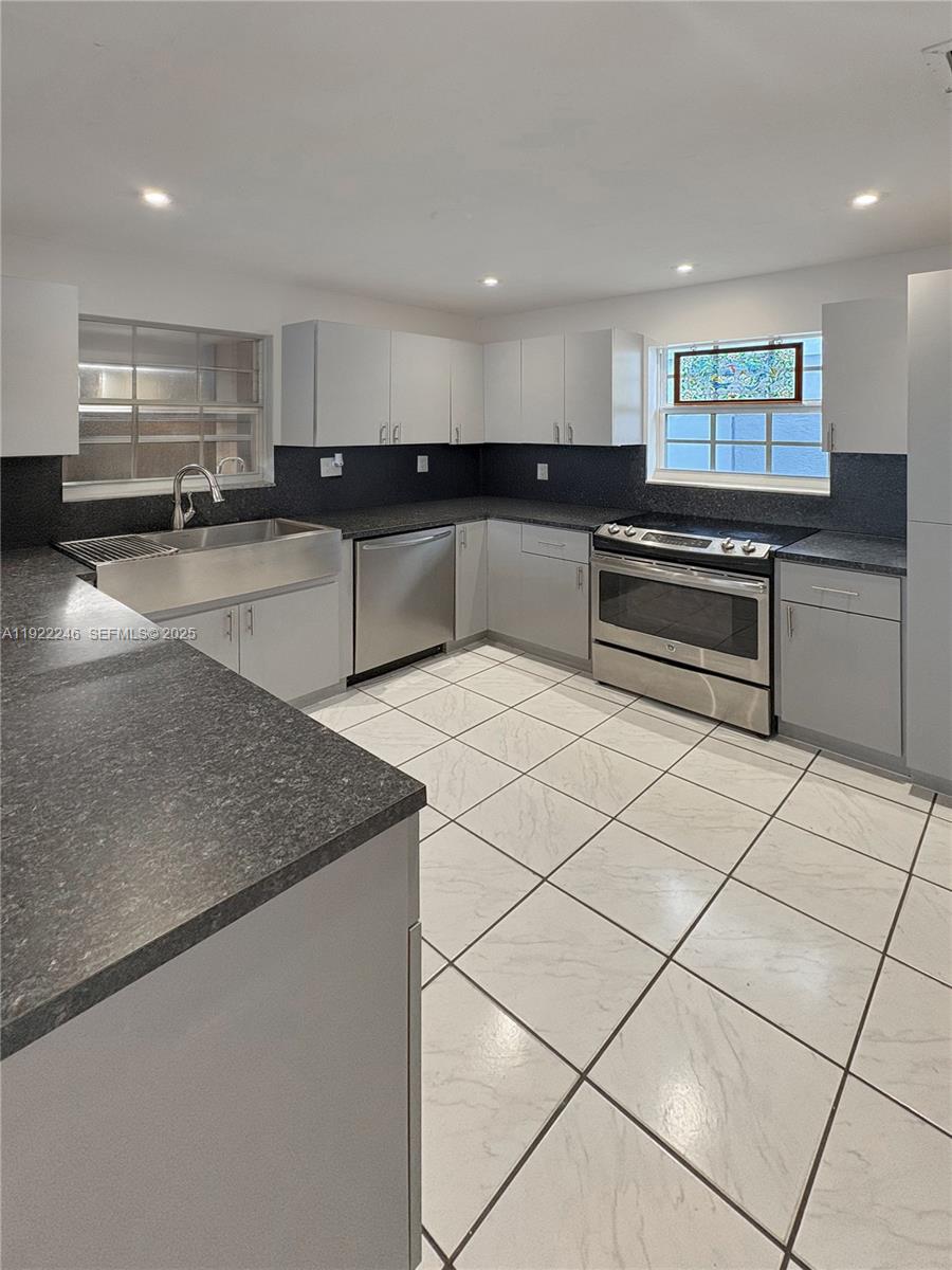 12759 Southwest 146th Terrace Miami, FL 33186 - Photo 8 of 10 a kitchen with stainless steel appliances granite countertop a sink and a stove