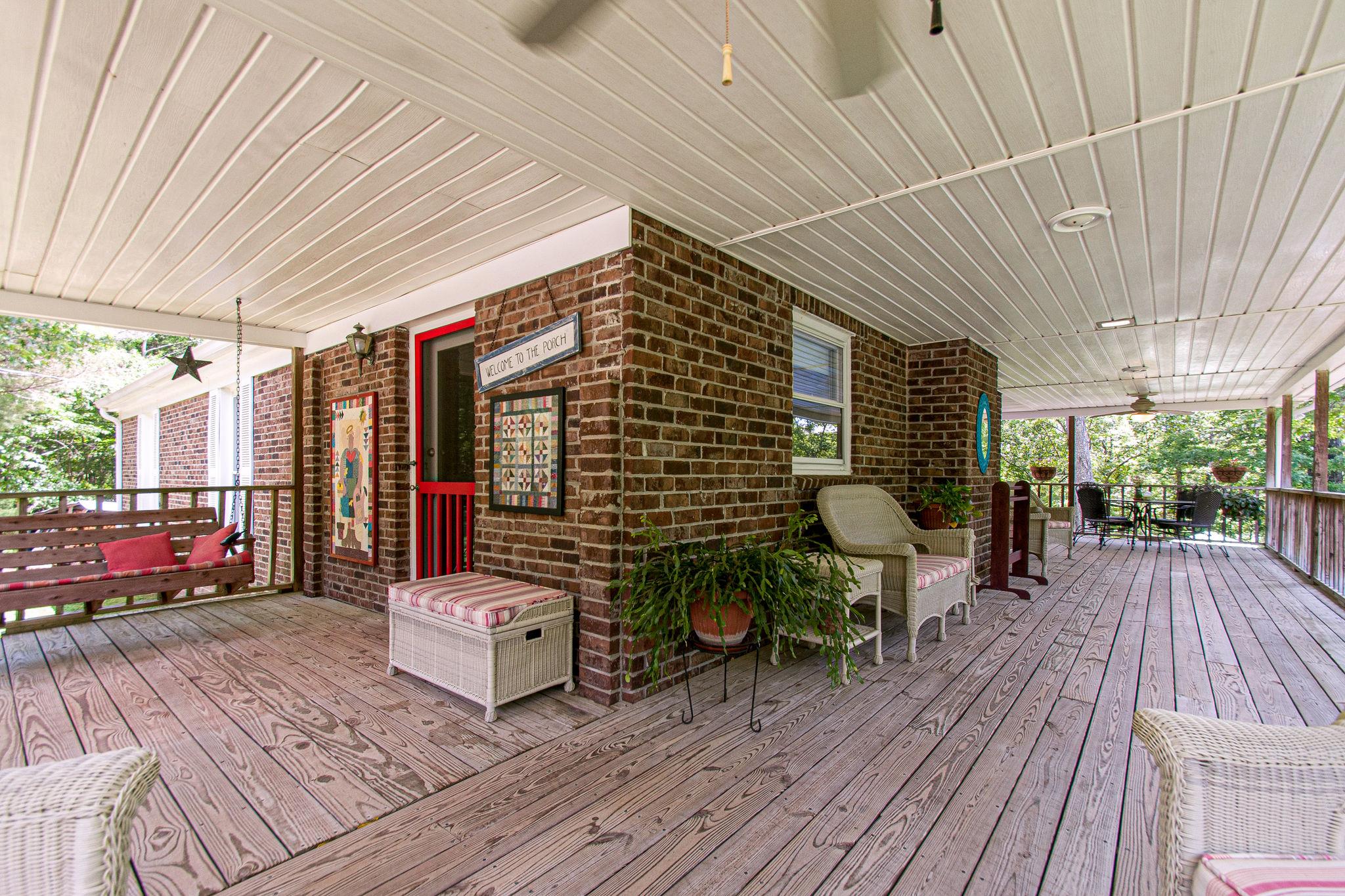 1296 Webb Ridge Road Kingston Springs, TN 37082 - Photo 3 of 30 Side porch/cover deck which goes around to the...