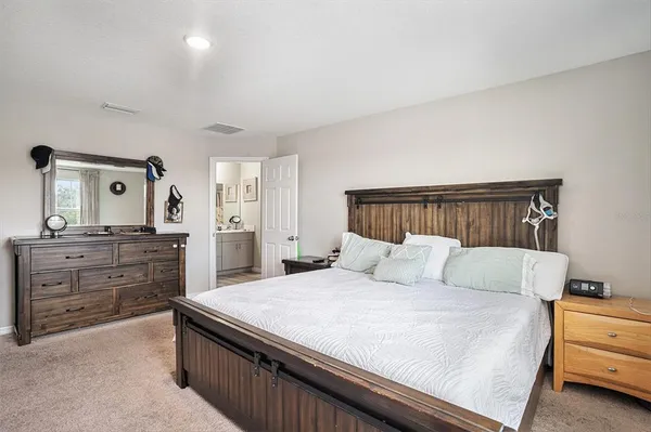a bedroom with a bed and a dresser