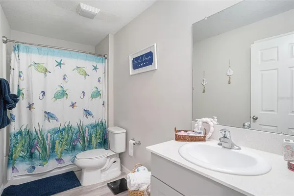 a bathroom with a toilet a sink and a bath tub