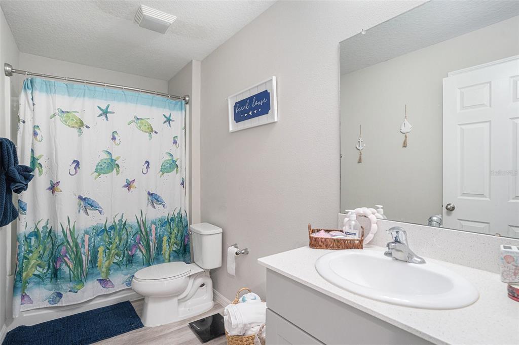 13005 Upward Place Riverview, FL 33579 - Photo 18 of 28 a bathroom with a toilet a sink and a bath tub