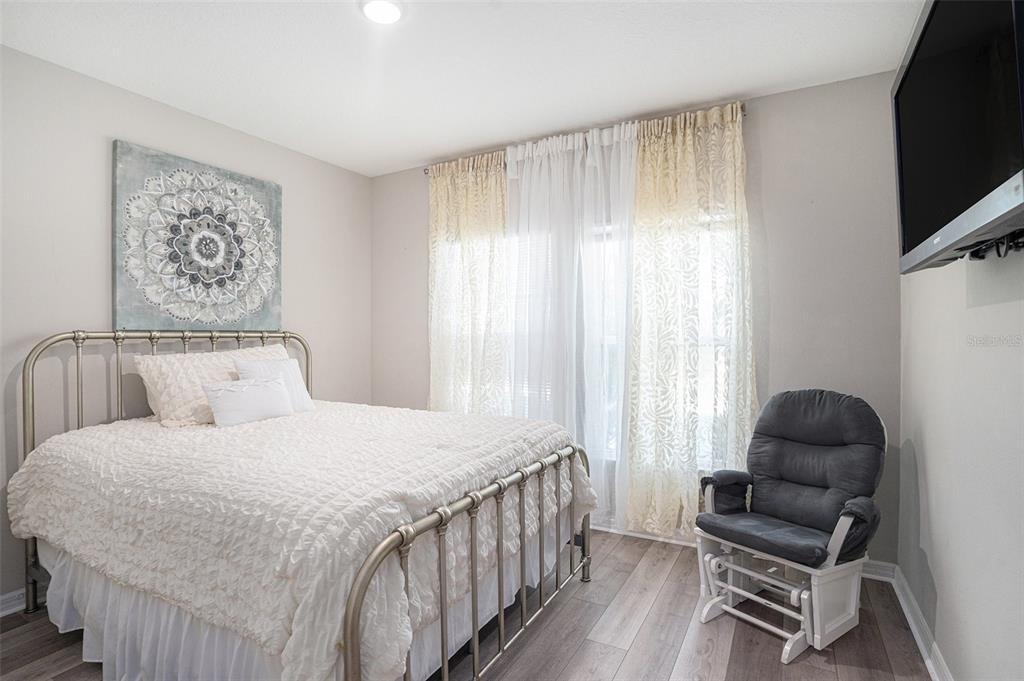 13005 Upward Place Riverview, FL 33579 - Photo 19 of 27 a bedroom with a bed and a couch