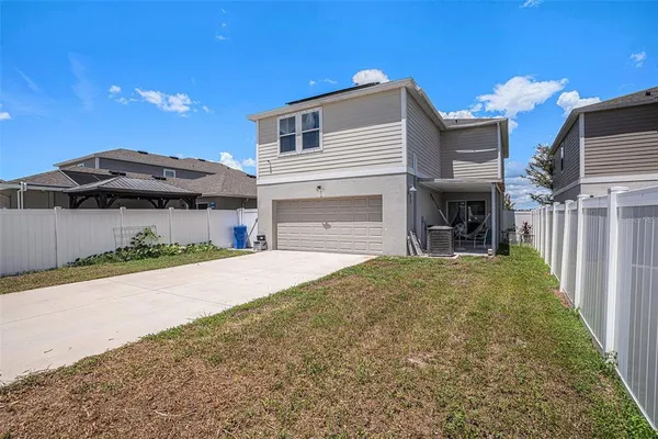 a front view of a house with a yard and a garage