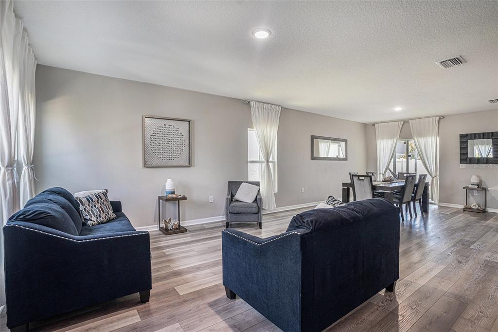 13005 Upward Place Riverview, FL 33579 - Photo 5 of 28 a living room with furniture and wooden floor