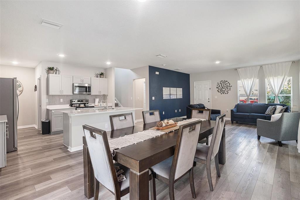 13005 Upward Place Riverview, FL 33579 - Photo 6 of 28 a view of a dining room with furniture and wooden floor