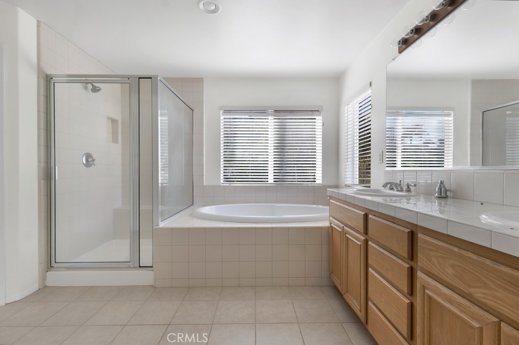 11205 Salerno Porter Ranch Porter Ranch, CA 91326 - Photo 36 of 43 a spacious bathroom with a granite countertop tub sink shower and a mirror