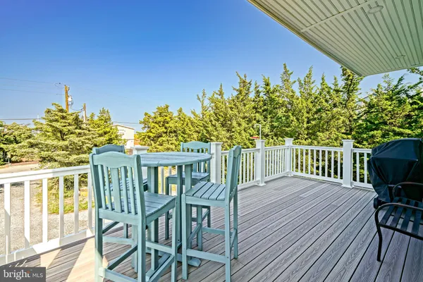 a view of a deck with table and chairs and wooden floor