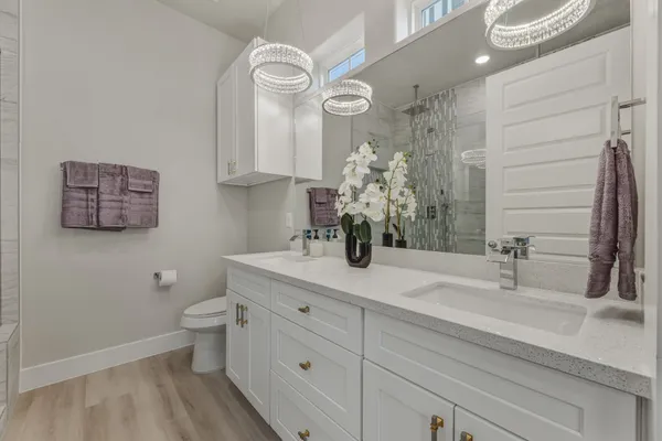 a bathroom with a sink a toilet and a mirror