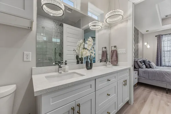 a bathroom with a double vanity sink mirror and toilet