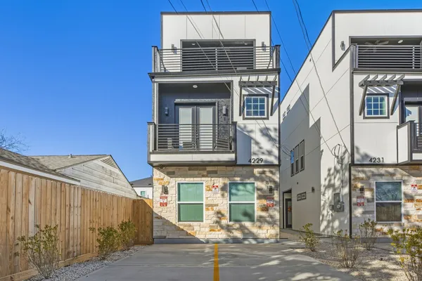 a front view of a house with a road